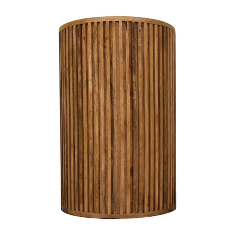 A cylindrical bedside table with vertical slats made from natural-toned solid mango wood reclaimed oak