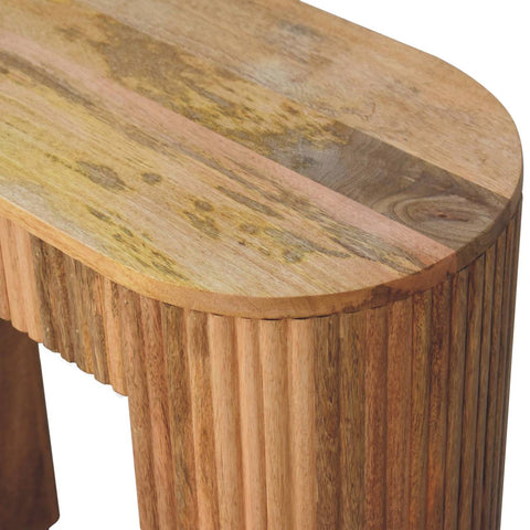 A rustic oval wooden soba straight console table with a natural weathered finish and vertical fluted legs