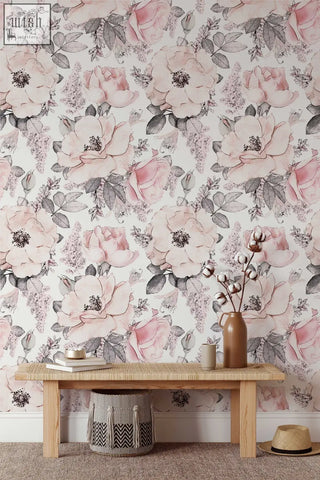 A rustic wooden bench with woven rattan top and basket under against soft pink abstract roses wallpaper for living space