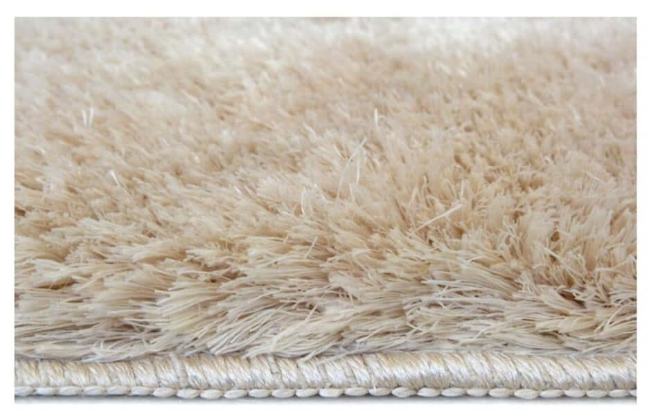 Soft washable beige shaggy rug with plush fluffy texture and silver toned finished border for cozy spaces