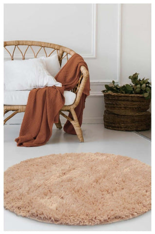 Soft washable beige shaggy rug with a round shape perfect for cozy living spaces and easy cleaning