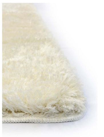 Cream-colored soft washable ivory shaggy rug with plush fluffy texture and neatly finished edge for cozy spaces