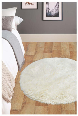 Cream-colored soft washable ivory circular rug with plush fluffy texture washable ivory shaggy carpet