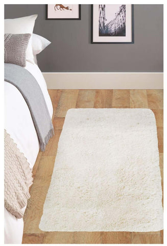 Soft washable ivory shaggy rug with a plush, fluffy texture perfect for cozy home decor and easy cleaning