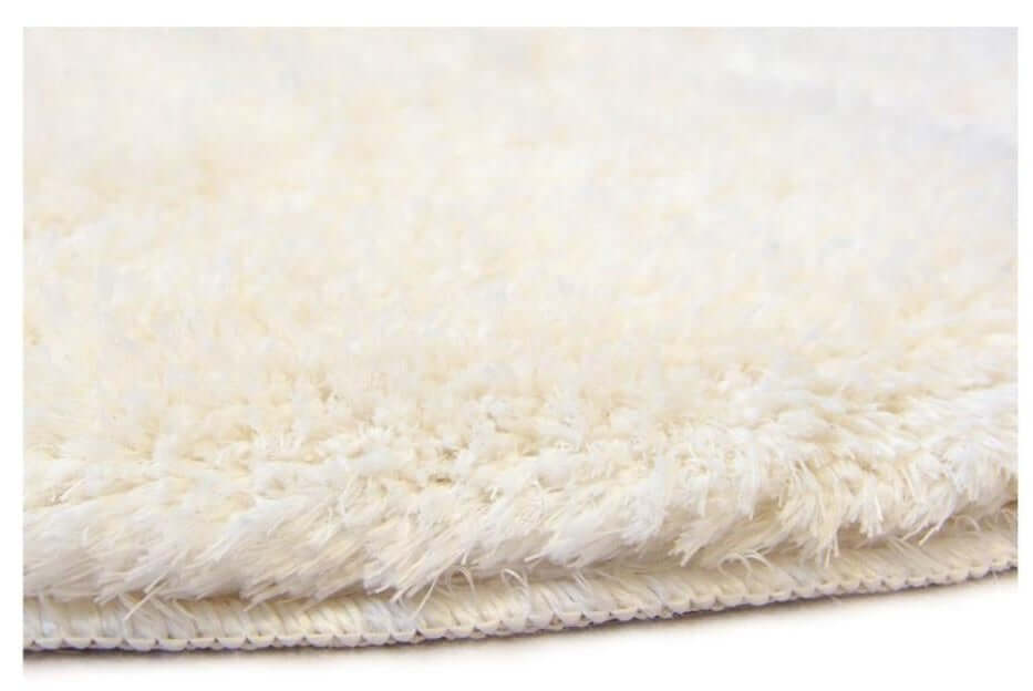 Soft washable ivory shaggy rug with plush fluffy texture and neatly stitched edge perfect for cozy spaces