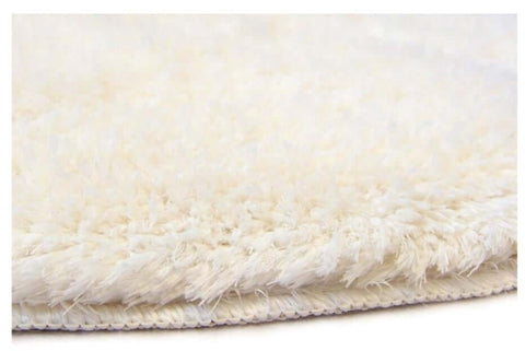 Soft washable ivory shaggy rug with plush fluffy texture and neatly stitched edge perfect for cozy spaces