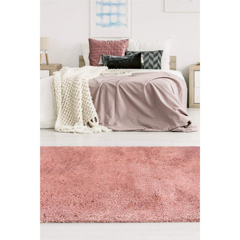 A plush dusty rose soft washable pink shaggy rug with a textured surface perfect for cozy spaces