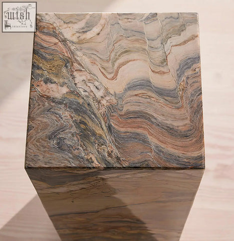 A polished solara plinth side table made from brazilian quartzite stone with beige gray and warm brown veining
