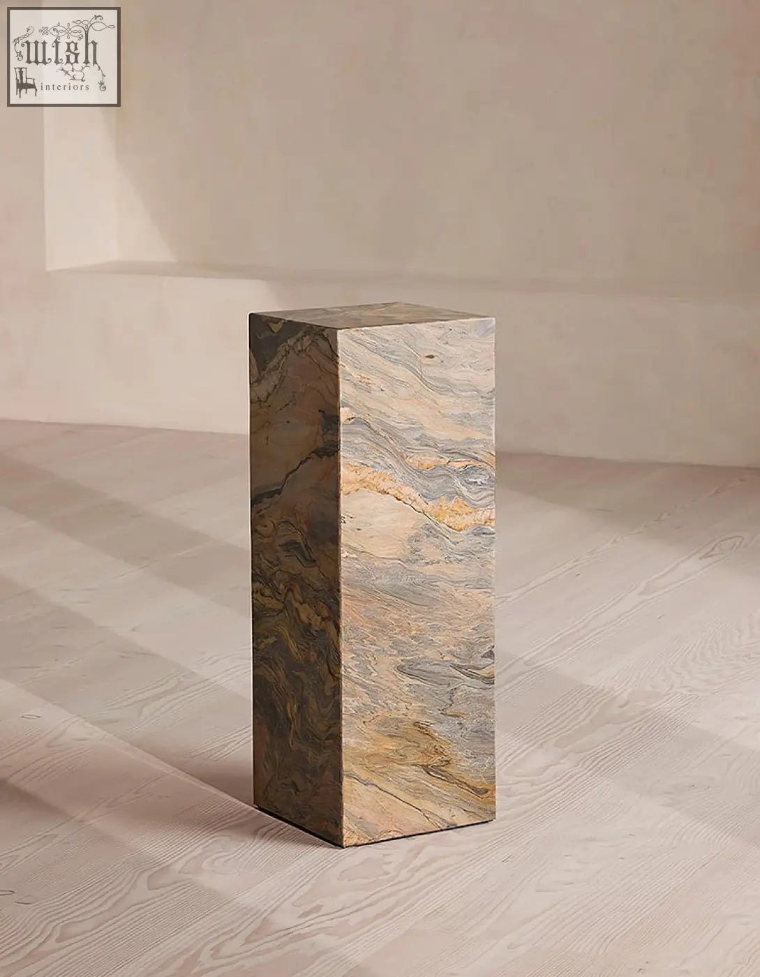 A solara plinth side table made of brazilian quartzite stone with beige brown and gold swirling patterns