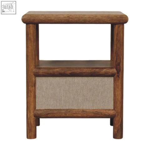 Solara rattan bedside table with rustic brown wood finish, two open shelves, and beige woven fabric panel