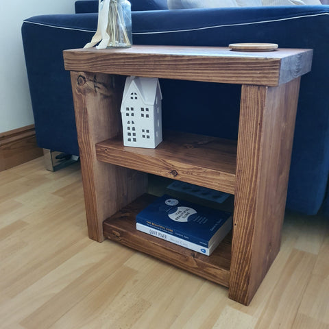 Solid wood rustic coffee table with two shelves showing natural wood grain and knots in a warm brown finish