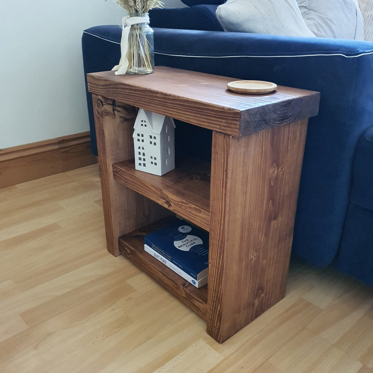 Solid wood rustic coffee table with natural wood finish and visible grain featuring a handy shelf
