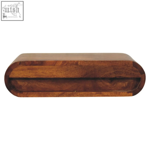 A sleek solis wall mounted bedside table made of natural mango wood with rich brown oval wooden box design