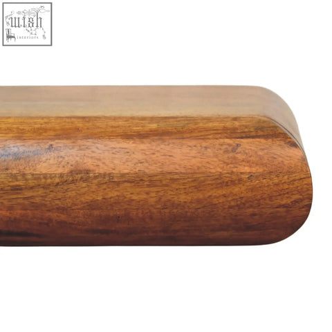 Smooth rounded wooden handle with warm brown finish and natural mango wood grain on solis wall mounted bedside table