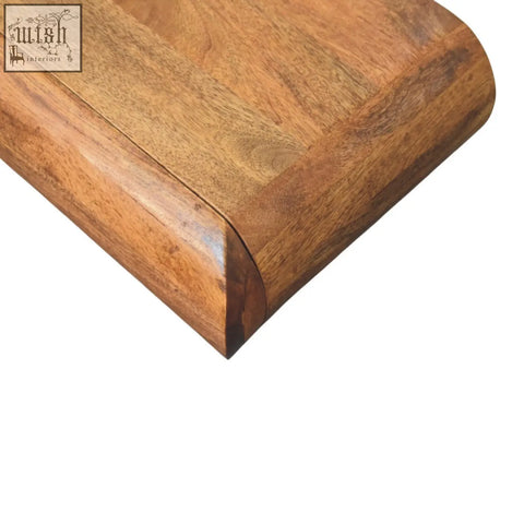 Corner of solis wall mounted bedside table in natural mango wood with smooth medium brown polished finish