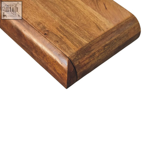 Corner of Solis wall-mounted console chest made of polished medium brown natural mango wood with visible grain