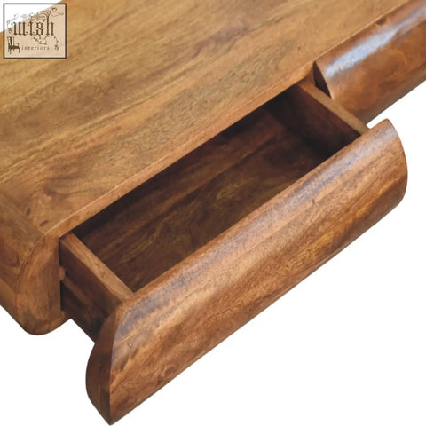 Solis wall-mounted console chest of drawers in warm medium-brown natural mango wood with smooth finish and curved drawer fronts