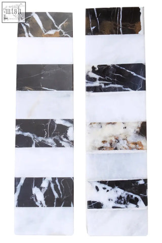 Two vertical strips of white striped marble with natural veining in the soma set striped marble bookends design
