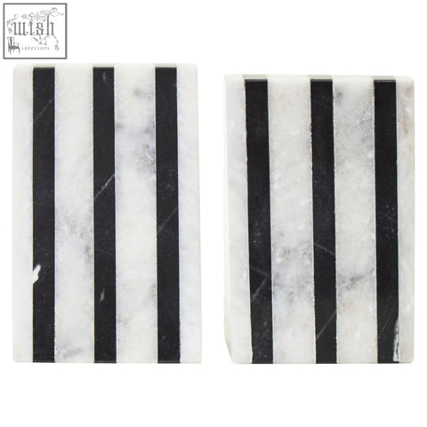 Black and white marble coasters with vertical stripes paired with white marble bookends for a stylish desk look