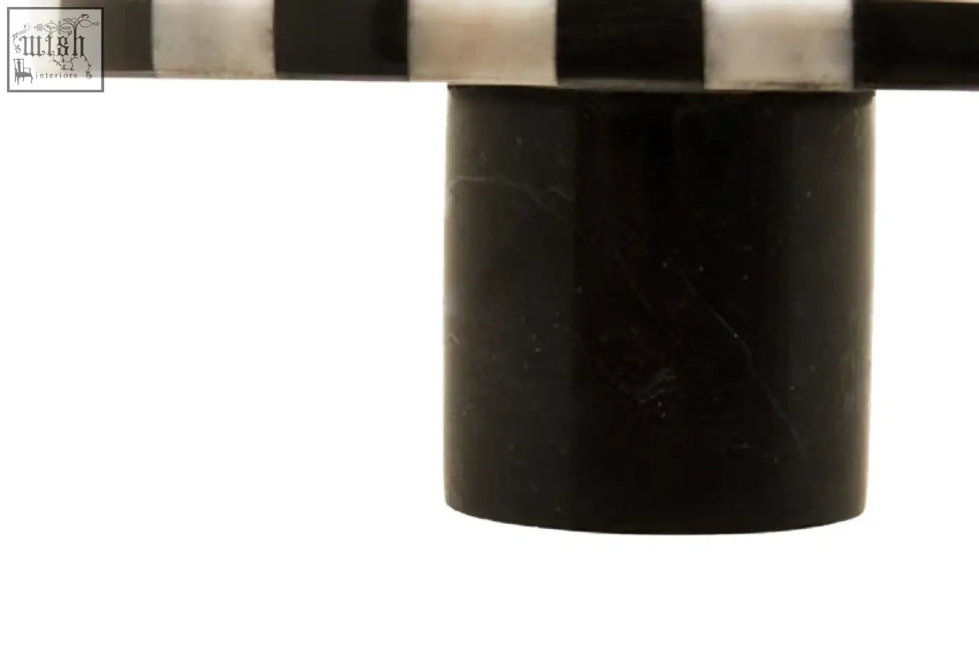 Black cylindrical marble base supporting a white marble round striped top for a marble round cake stand