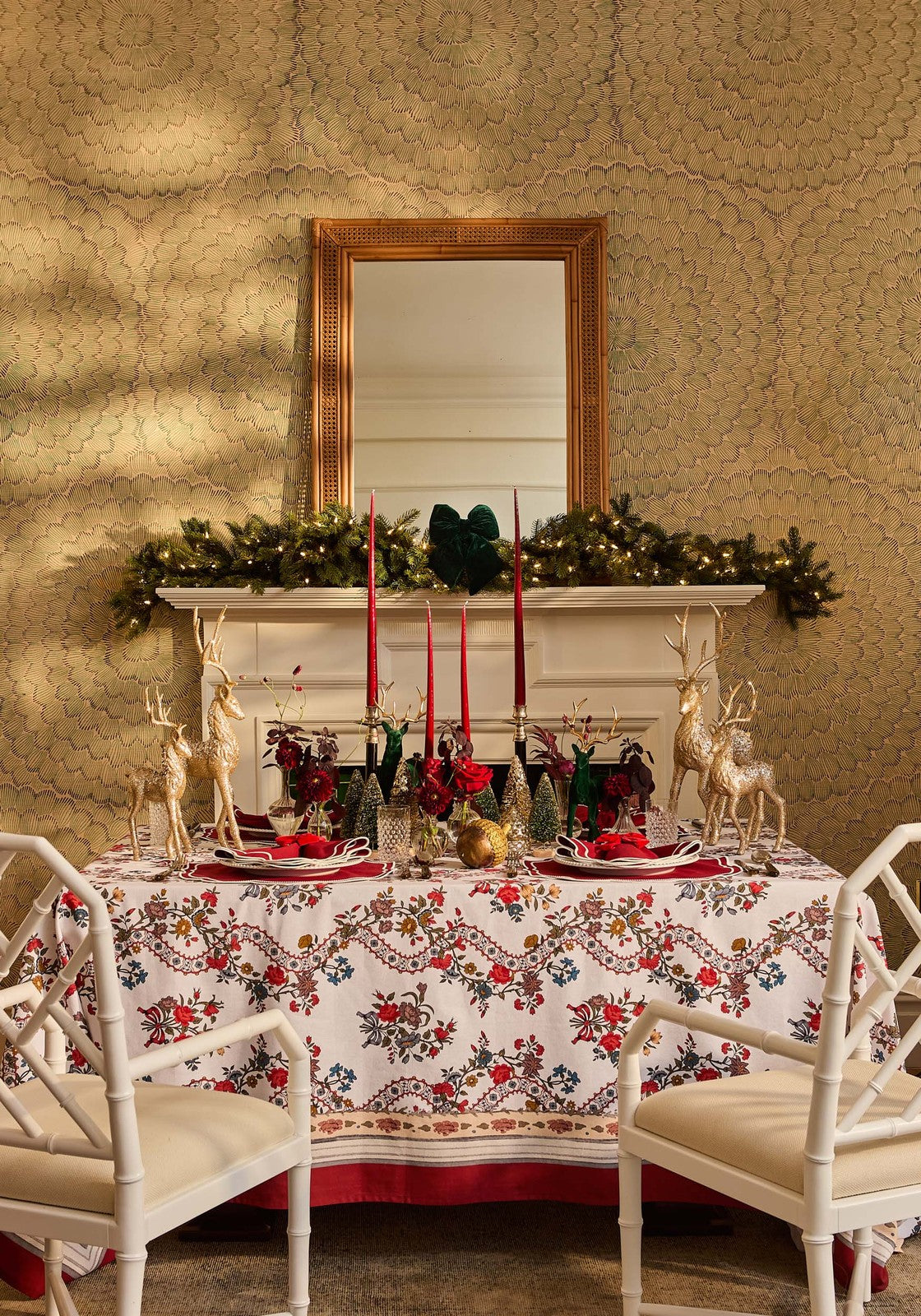 A festive sommerset scroll red cotton tablecloth with white base gold deer and holiday floral decorations