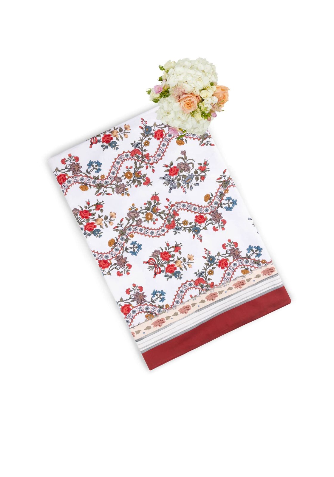 A white sommerset scroll red cotton tablecloth with vibrant red blue pink floral embroidery and a solid burgundy border