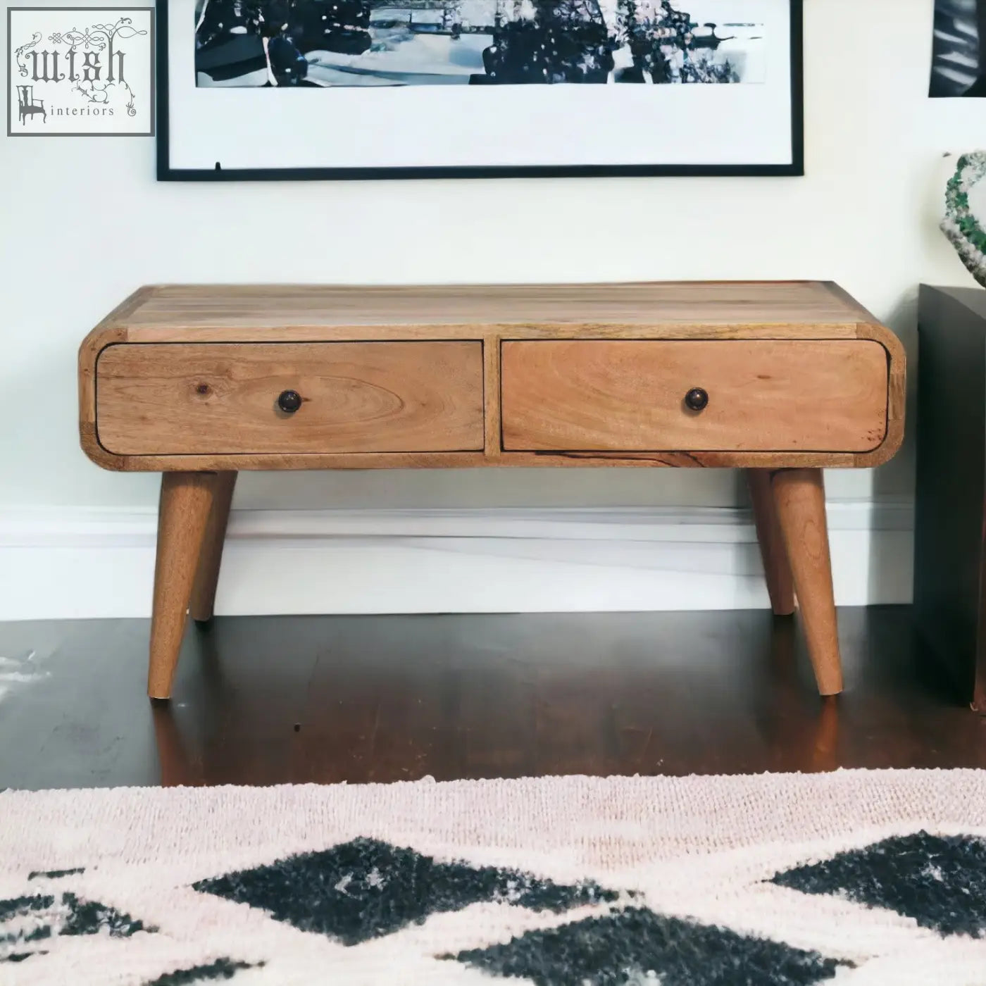 Light brown wooden sonata oak-ish coffee table with oak-like finish, rounded edges, two drawers, and tapered legs