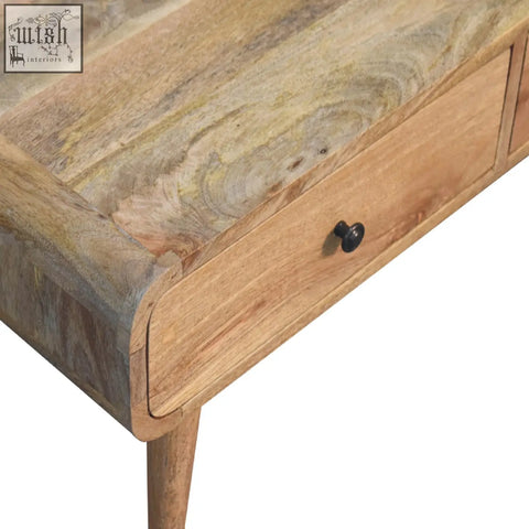 A rustic coffee table with an oak-like finish, rounded edges, and a single drawer with a black round knob