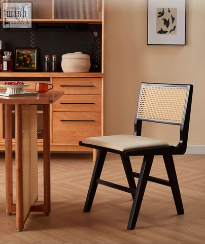 Black-framed cane-back sophia rattan dining chair with beige upholstered seat perfect for dining rooms