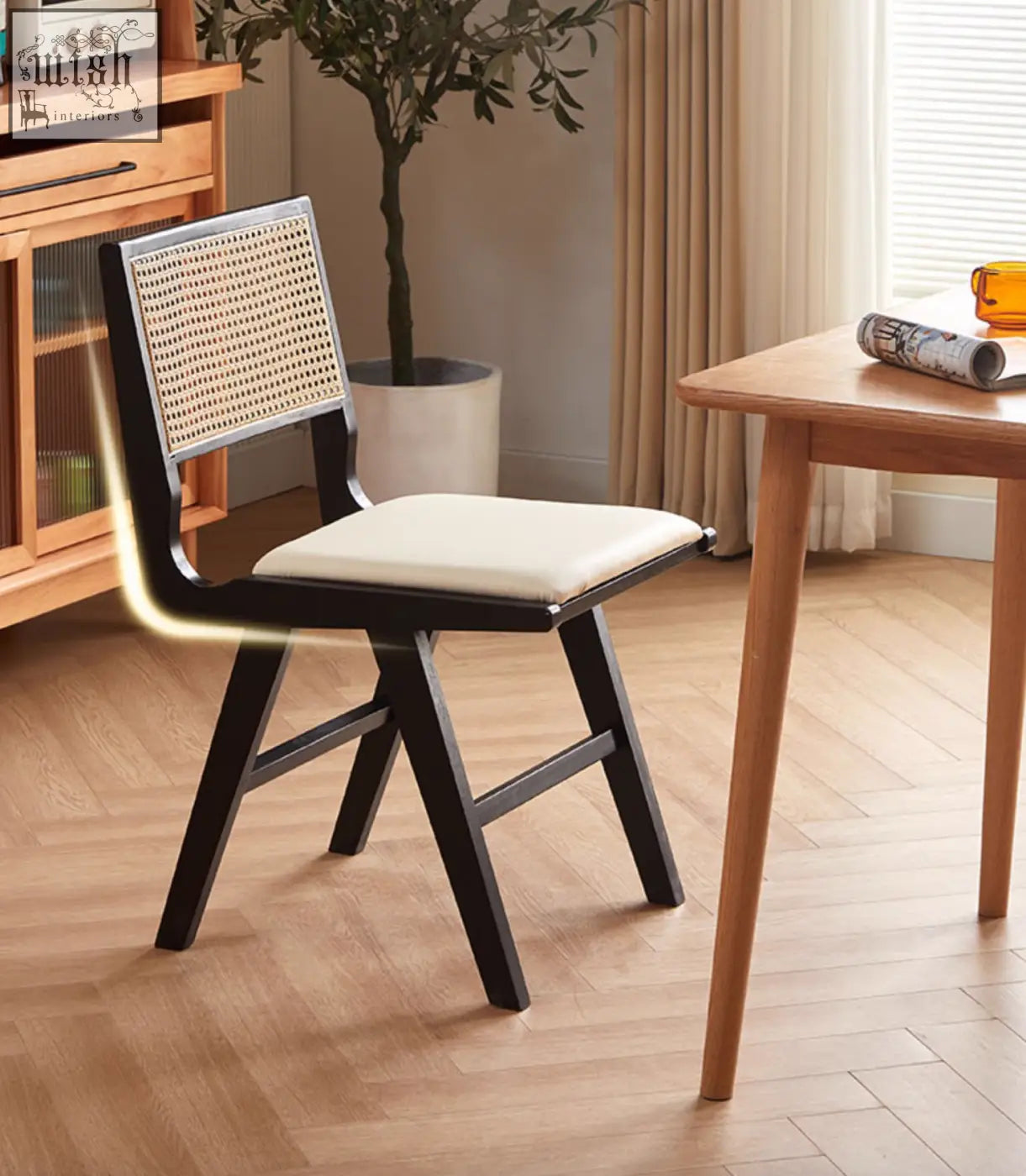 Black-framed cane-back sophia rattan dining chair with cream upholstered seat perfect as a dining chair