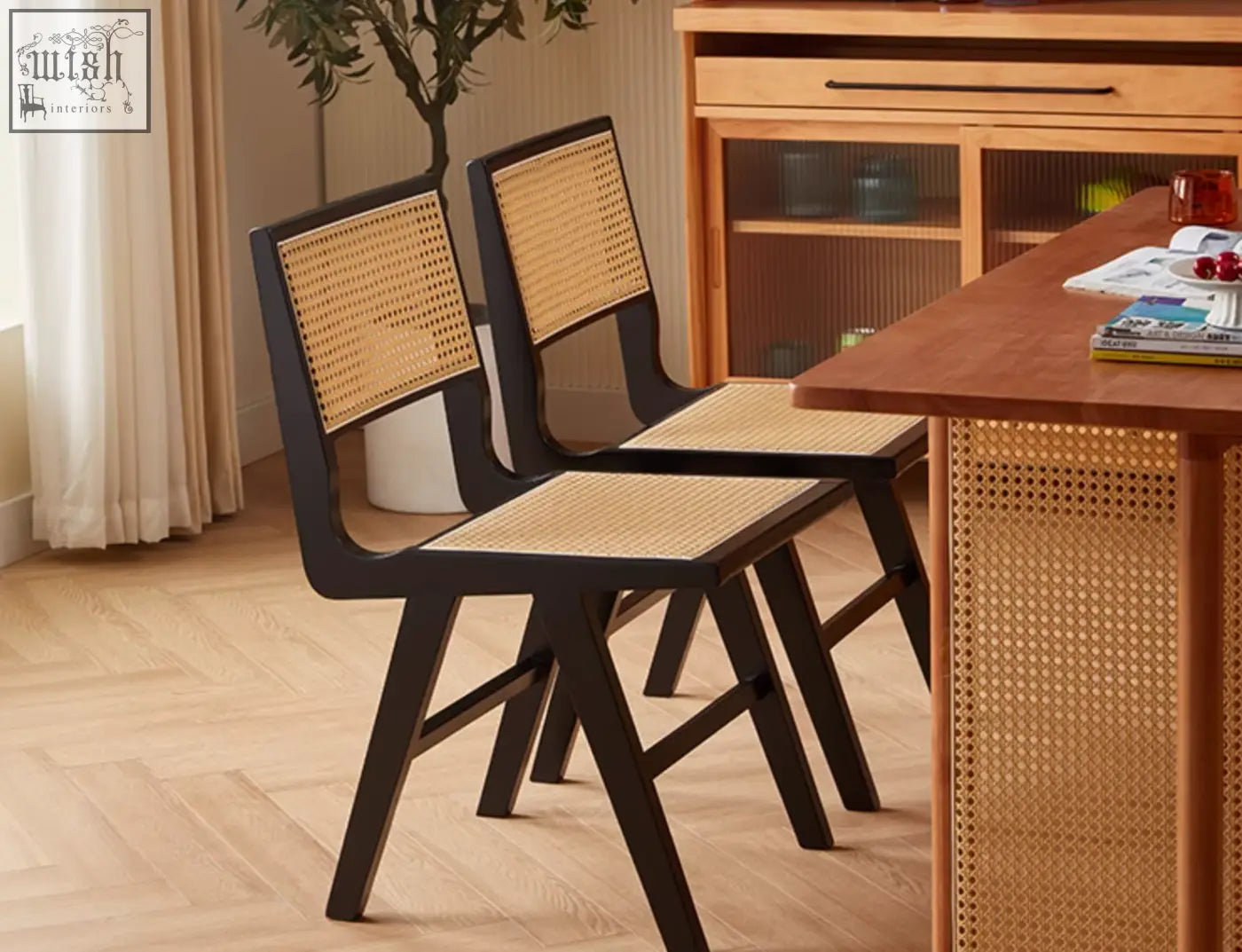 Black-framed sophia rattan dining chair with woven natural-toned seat and back perfect for dining room use