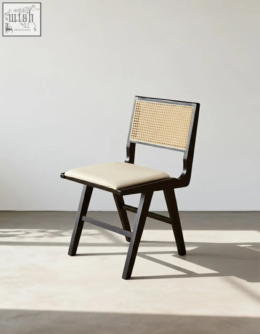 Black-framed sophia rattan dining chair with woven cane back and beige upholstered seat for dining room use