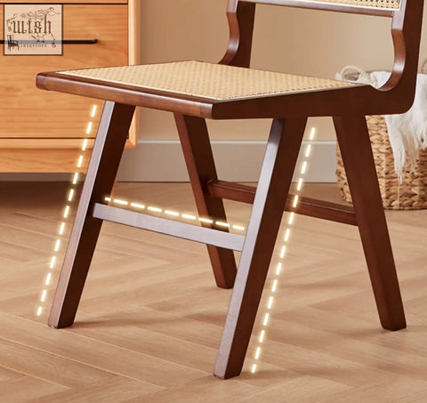 Sophia rattan dining chair with dark wood frame woven natural fiber seat and sleek metal legs perfect dining chair