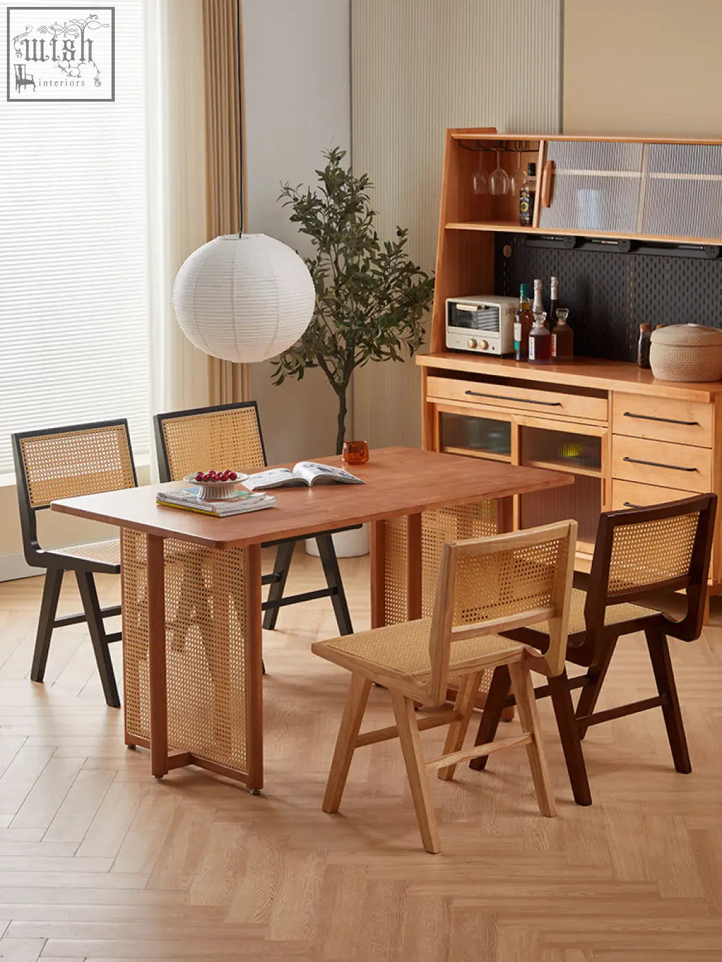 A rectangular wooden dining table with natural finish and woven cane panels paired with matching sophia rattan dining chairs