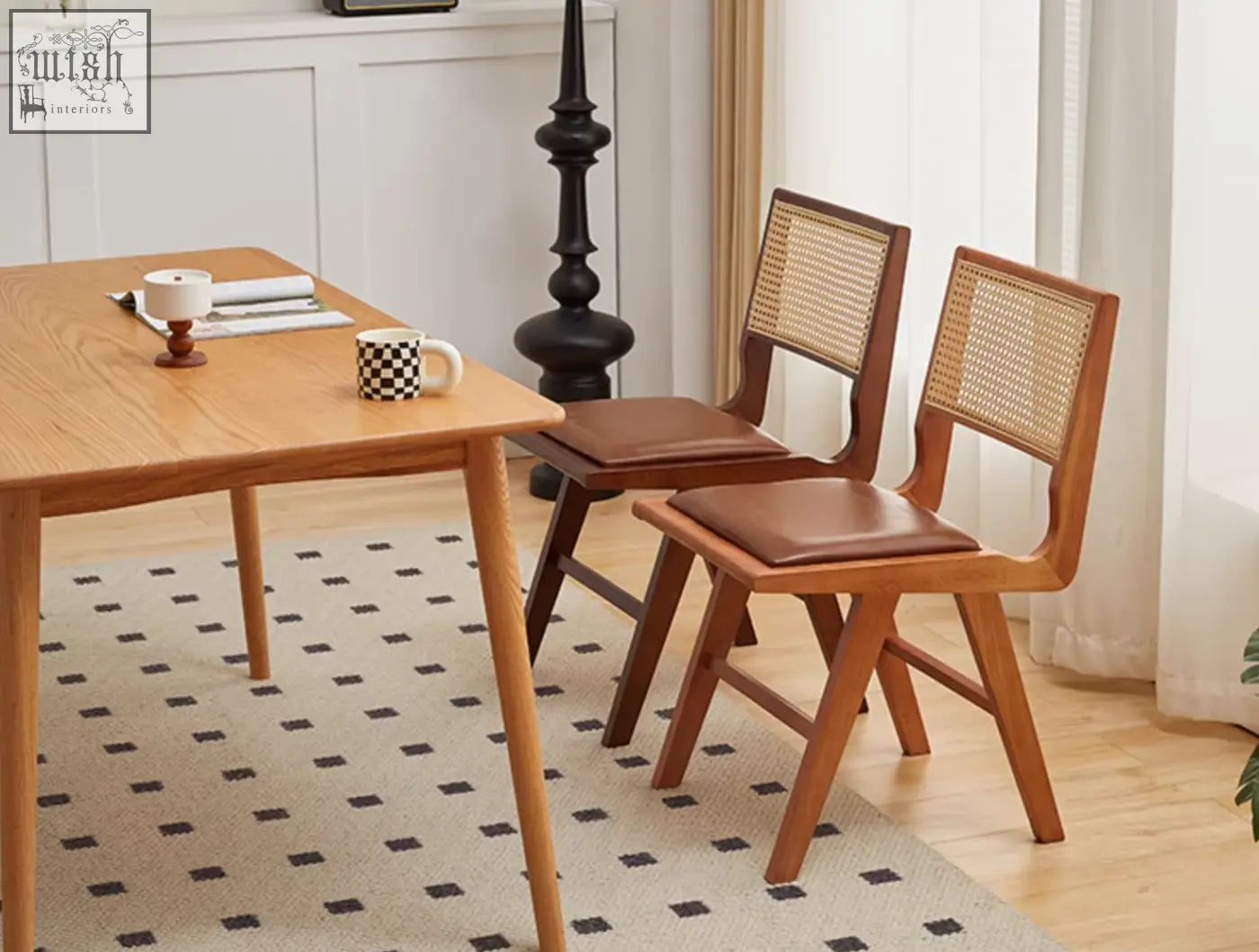 Two sophia rattan dining chairs with woven cane backs and brown leather seats perfect as dining chairs