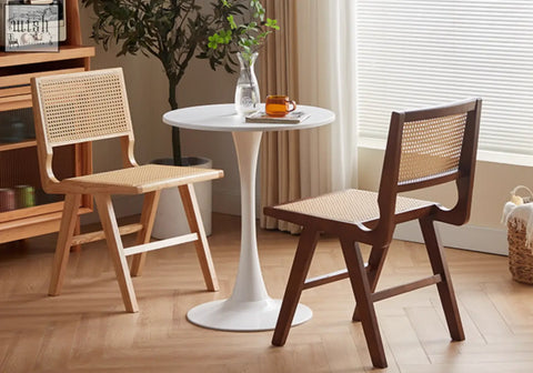 White round table with sleek pedestal base pairs well with sophia rattan dining chair for a stylish dining setup