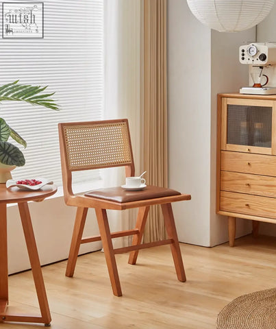 Wooden sophia rattan dining chair with woven cane back and brown leather seat perfect for dining room use