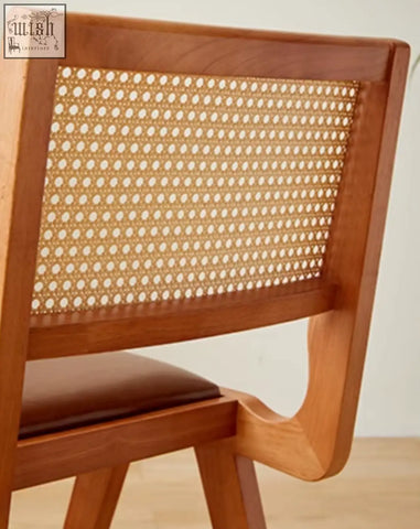 Wooden sophia rattan dining chair with woven cane back and brown leather seat perfect for dining room use