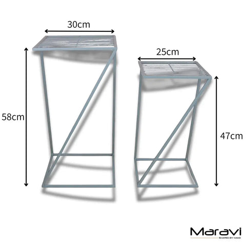 Two minimalist metal plant stands in green garden table set with slatted tops for stylish green garden decor