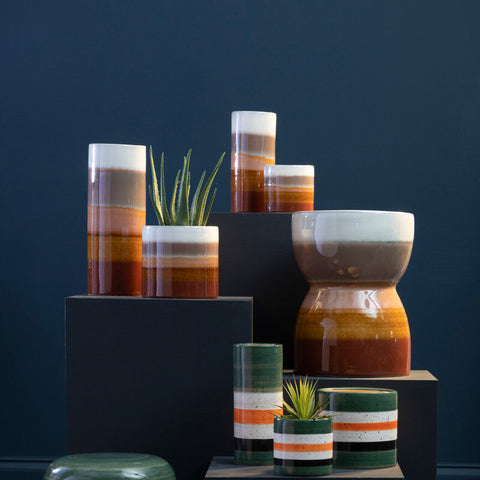 A glossy sorrell small multicoloured ceramic vase with layered amber terracotta and cream hues perfect for plants