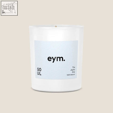 A minimalist white glass standard candle jar with a light blue eym label and soul scent in black text