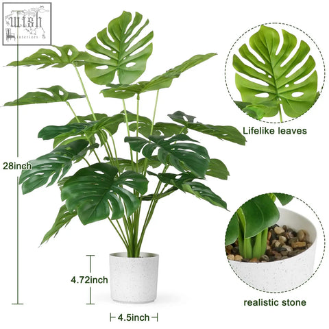 A 28 inch tall fake tropical palm tree monstera plant with vibrant green leaves in a speckled white ceramic pot
