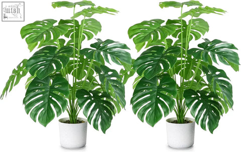 Two identical fake plants tropical palm trees with lush green split leaves in white speckled pots for indoor outdoor use