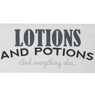 Gray spa storage caddy with a lotions and potions sign and cursive subtitle for organizing spa essentials