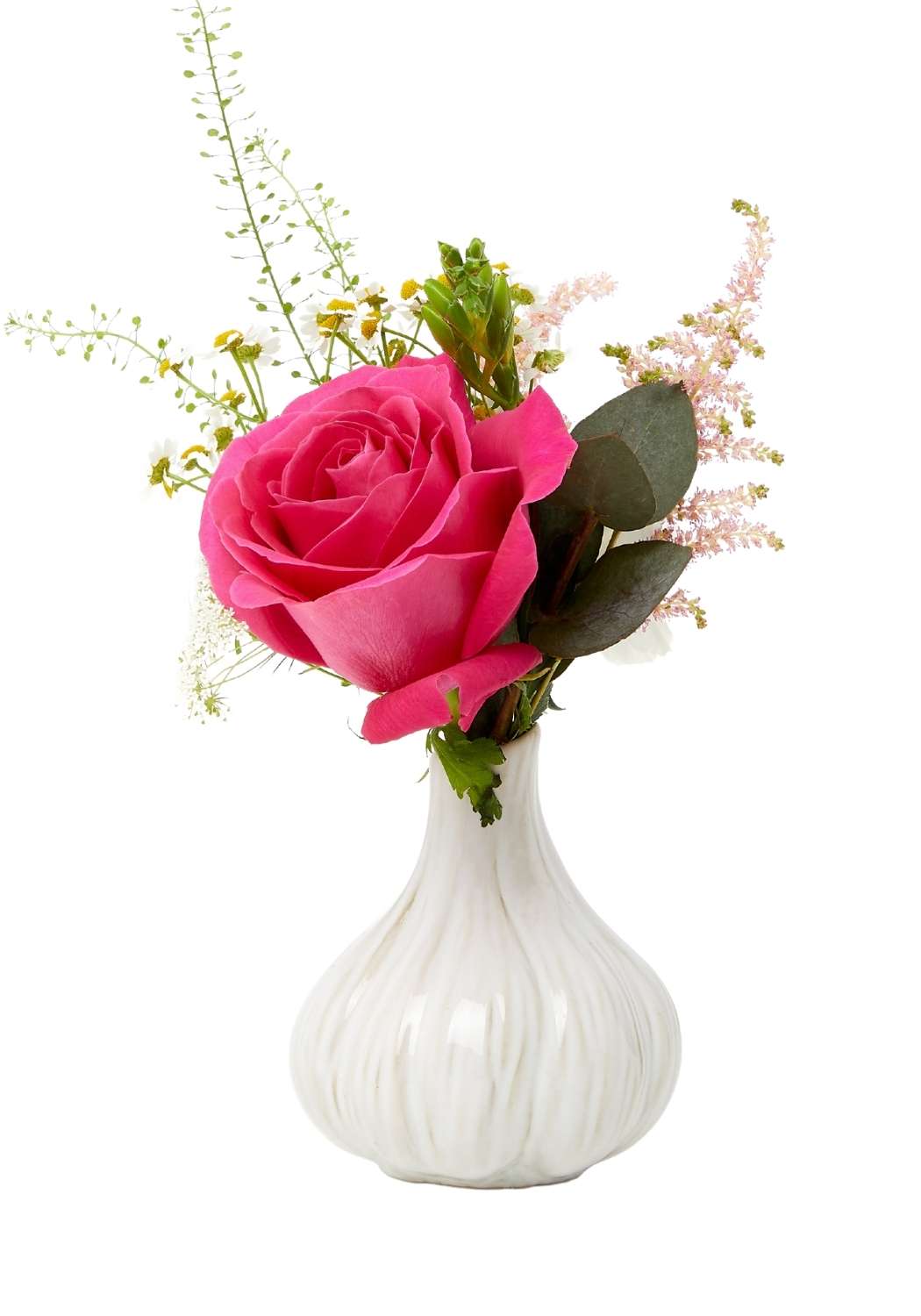 A white ceramic ribbed garlic bud vase holding a vibrant pink rose with greenery and soft pink filler flowers