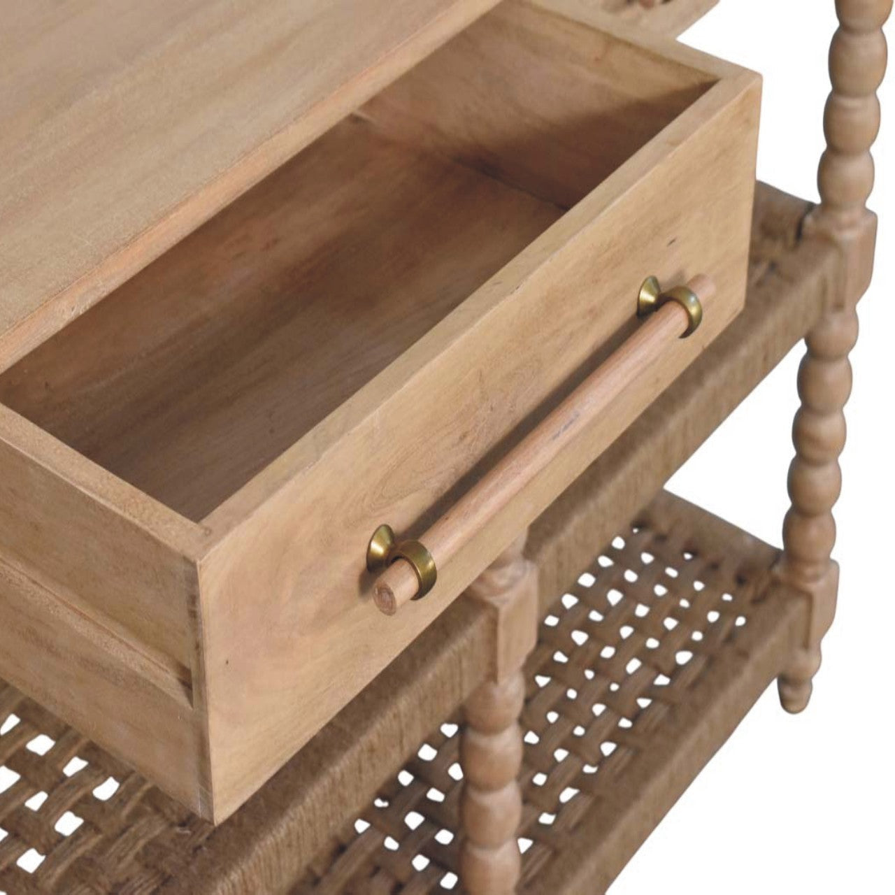 Light-colored wooden spindle console table with two drawers brass handles and woven rattan shelf stone driftwood finish