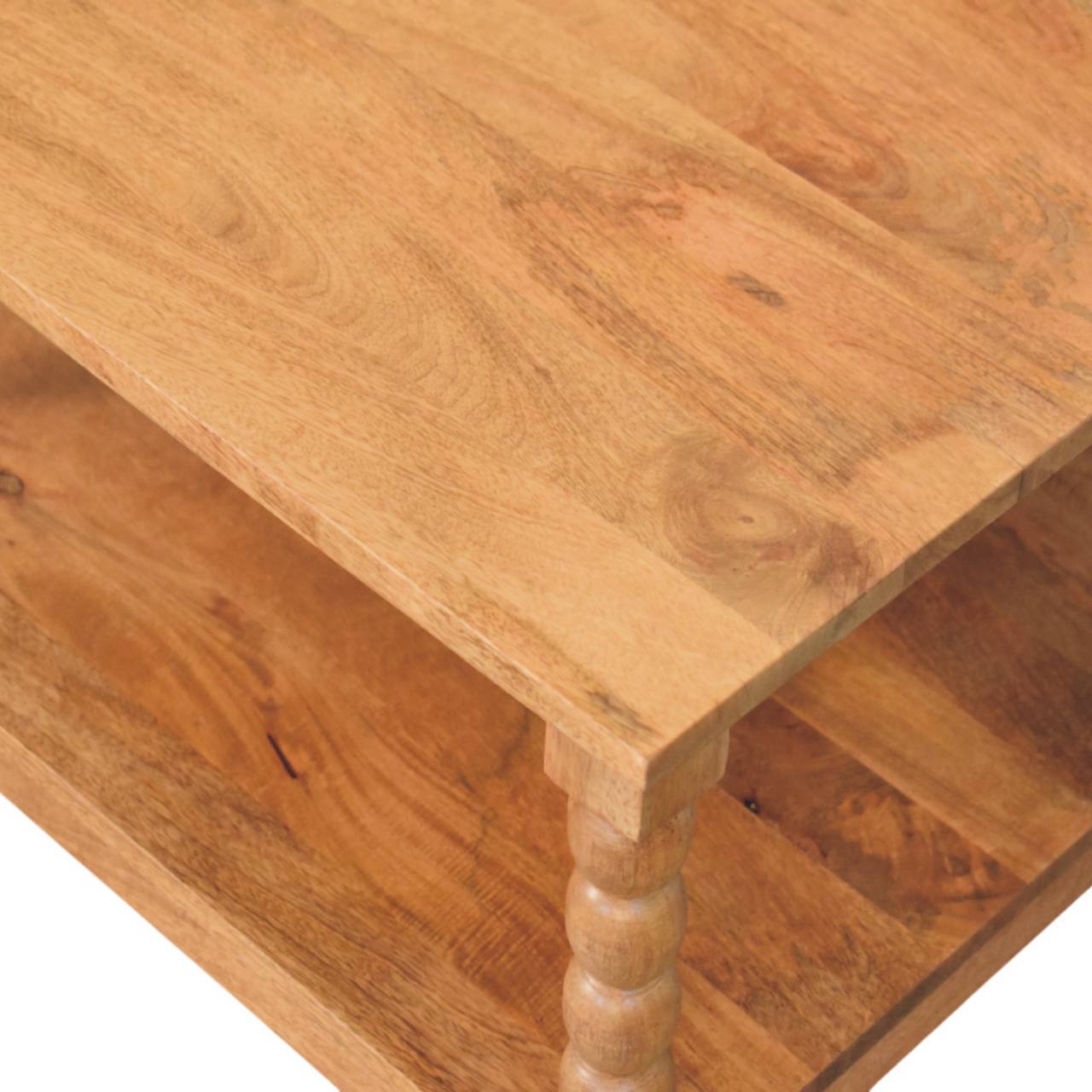 Light brown golden teak coffee table with rustic finish and turned spindle legs perfect for living room seating area