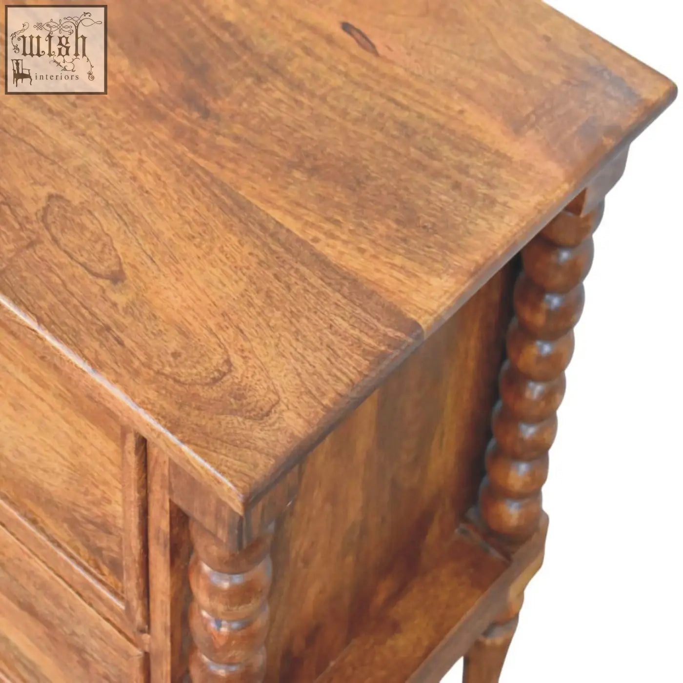 A warm amber oak bedside table with turned spindle legs and smooth finish perfect for any bedroom