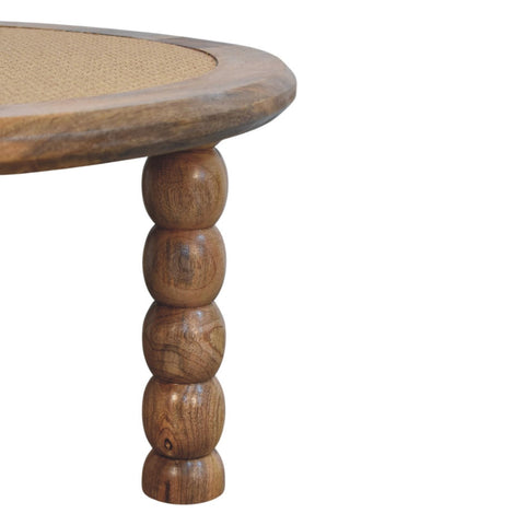 Round wooden spindle rattan coffee table with natural finish and turned ball legs perfect for living room use