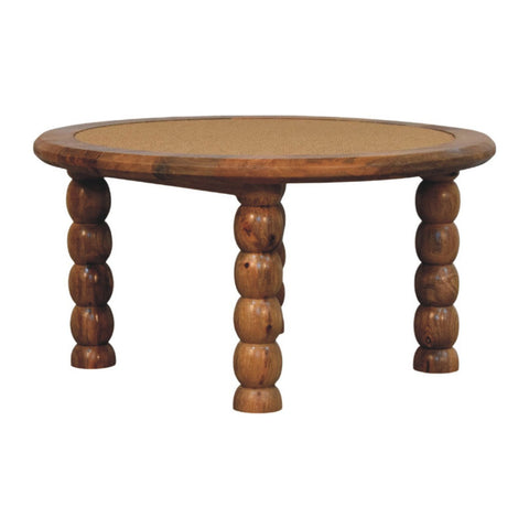 Round wooden spindle rattan coffee table with woven cane top and turned ball and rod legs for living room use